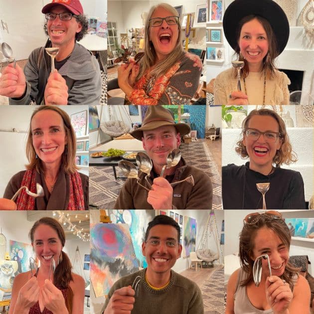 LightNet community members holding up bent spoons